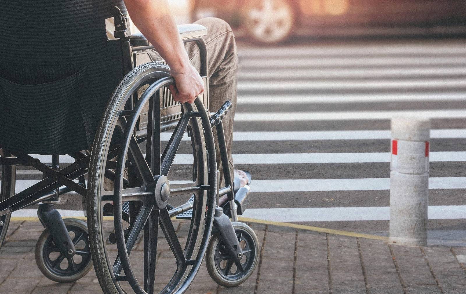 Man on a wheelchair on pavement