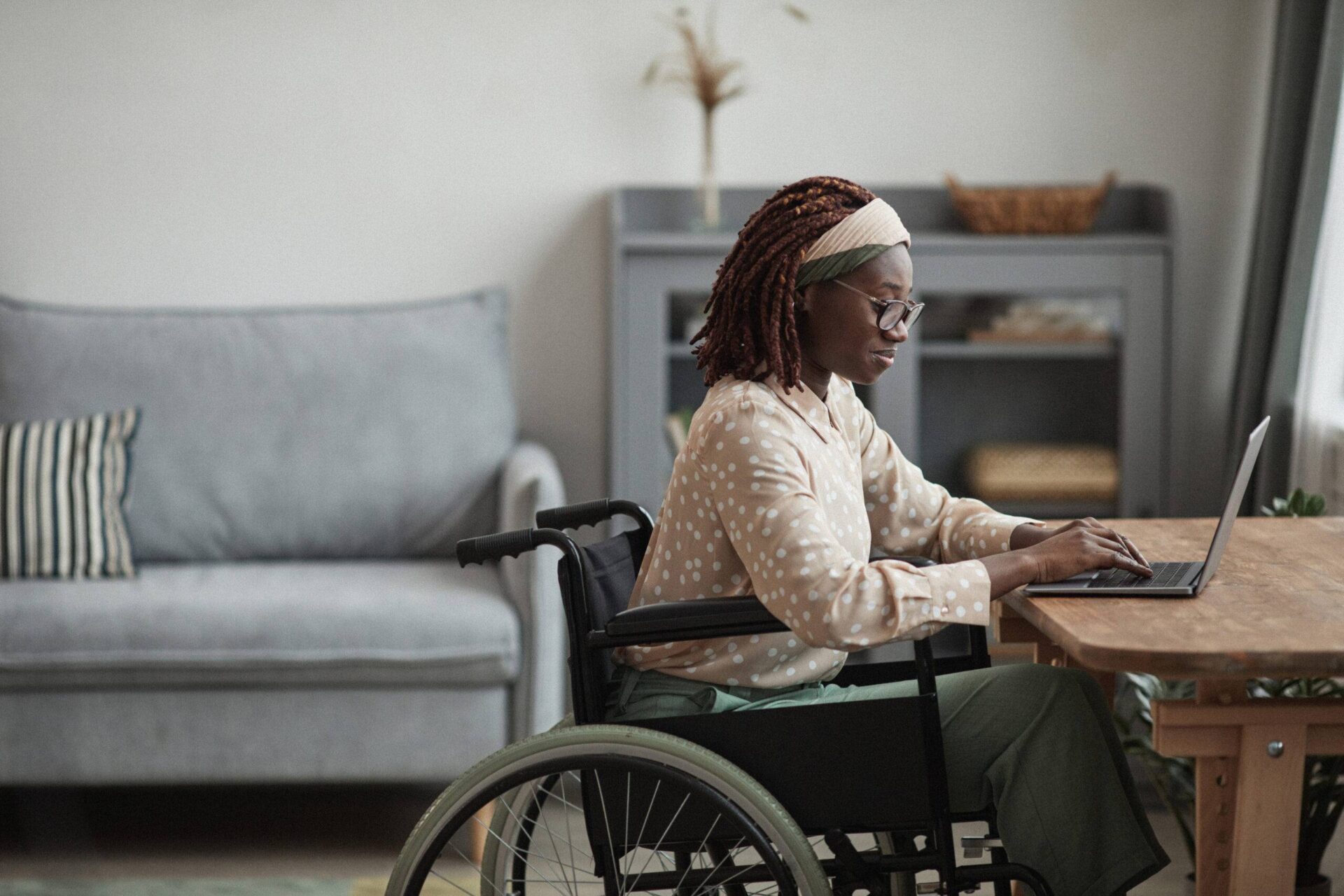 Woman in wheelchair on her laptop apply for a blue badge