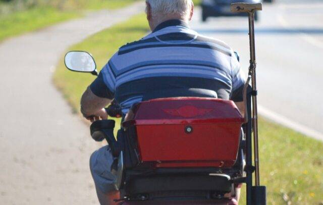 Mobility scooter riding on pavement