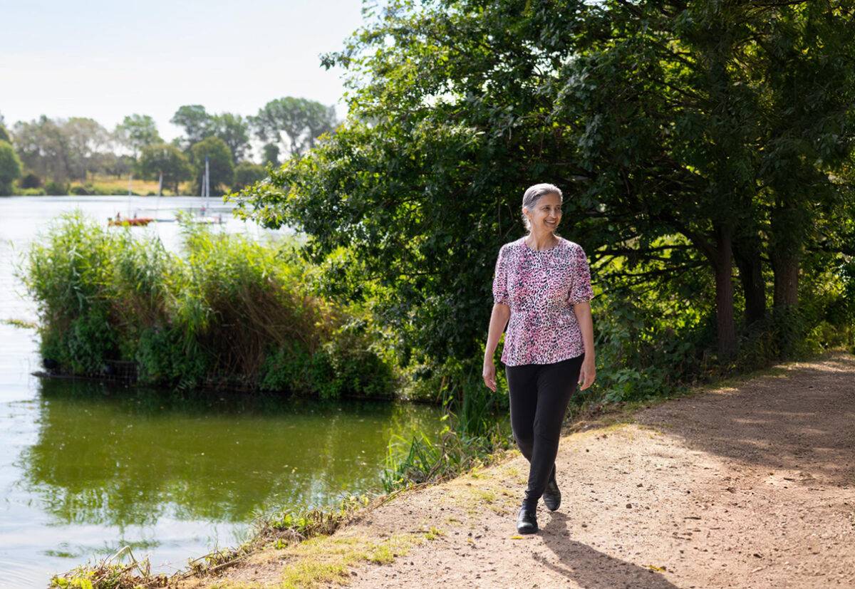Women walking next to lake