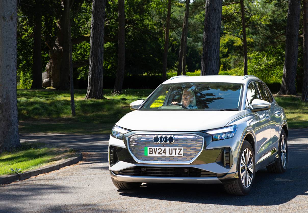 Women driving a car through the woods
