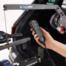 The Autochair Smart Lifter LM Folding Boot Hoist. A lightweight, folding grey hoist arm with a red handle.
