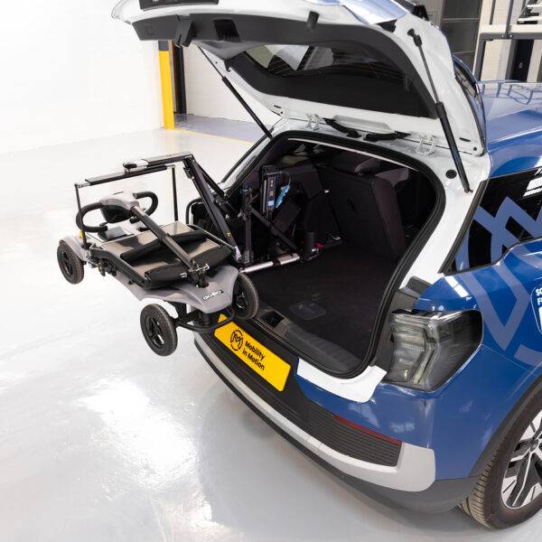 The back of a car with its boot open. A Boot Hoist is holding up a scooter. A Power Pack is attached to the frame of the boot hoist.
