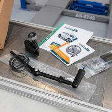 a work bench with the component parts of hand controls laid out