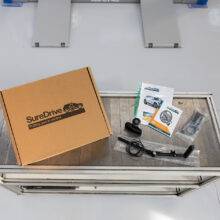 a work bench with the component parts of hand controls laid out