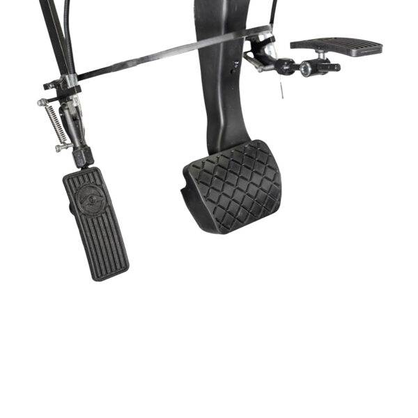 A Left Foot Accelerator Pedal. The accelerator is folded up and out of the way, a second accelerator pedal has been folded down to the left of the accelerator pedal.