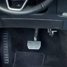 A driver's seat view of a car interior. In the footwell the accelerator is folded up and out of the way.