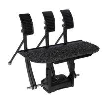 An array of three pedals mounted on a raised floor platform to extend a car's original pedals.