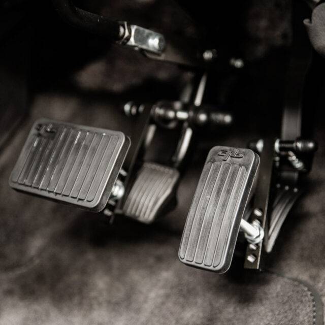 Pedal extensions mounted to the accelerator and brake pedals of a car