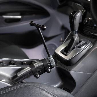 A car's handbrake with a minimalist T-shaped handle attached to it.