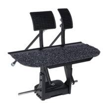An array of two pedals mounted on a raised floor platform to extend a car's original pedals.