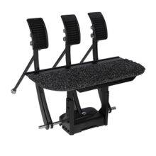 An array of three pedals mounted on a raised floor platform to extend a car's original pedals.