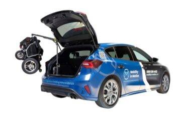 mobility in motion demo vehicle with boot hoist lifting a folded powerchair