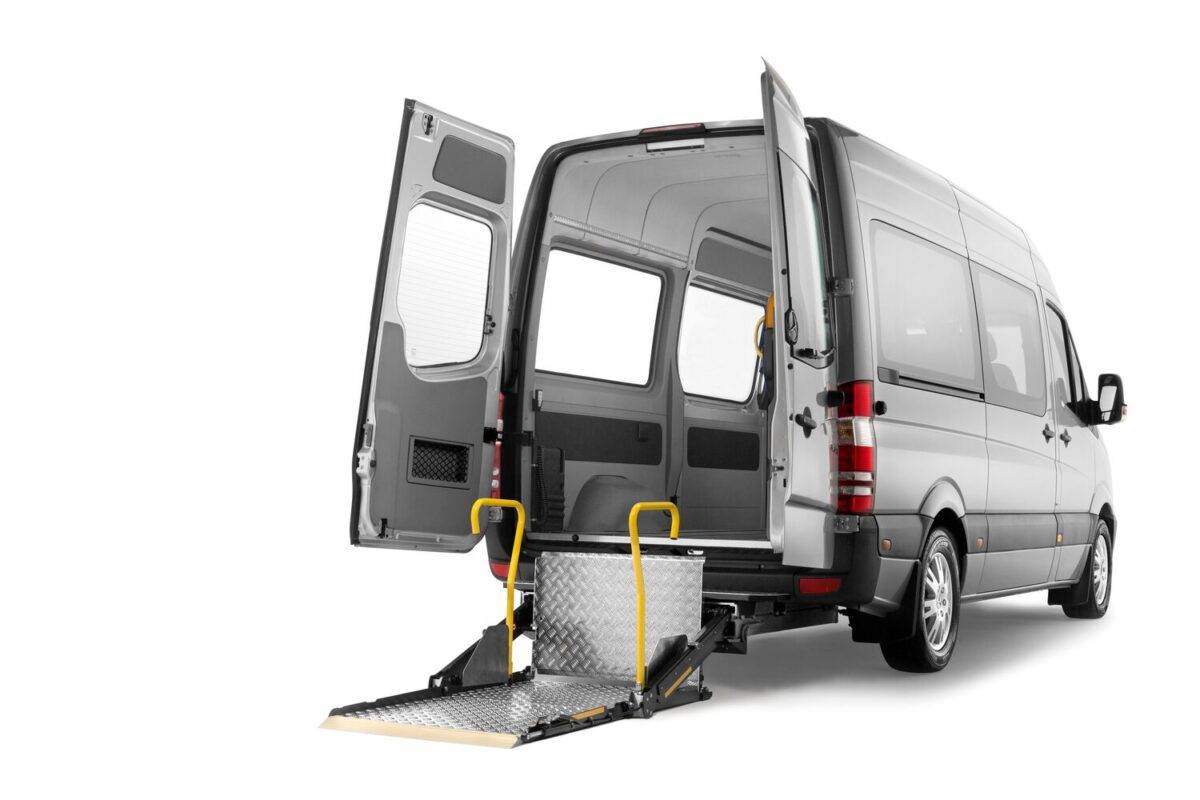 White van with rear open showing the BraunAbility A-series lift