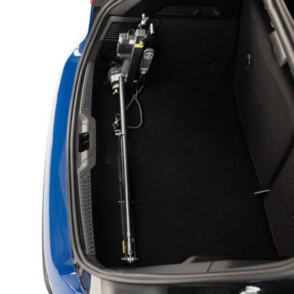 The boot of a Ford Focus with the Brig-Ayd 40kg Boot Hoist, a tall, slender, folding and collapsible hoist arm with a green lifting cord and clip for multiple types of mobility device. It is folded and collapsed down into its transporting position taking up very little boot space.