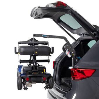 The open boot of a car with the Autochair Smart Lifter LM Folding Boot Hoist lifting a mobility scooter. The scooter has the Autochair Smart Scooter seat installed. It has had the arms and backrest removed so it can be lifted more easily and fit the vehicle.