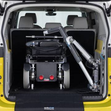 The open boot of the electric VW ID Buzz showing a large power chair loaded into the boot by the Autochair Smart Lifter LP Boot Hoist.