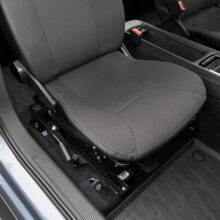 A swivel seat in the driving position of the driver's seat inside the car. The manual handle to turn the seat is visible to the left of the seat.
