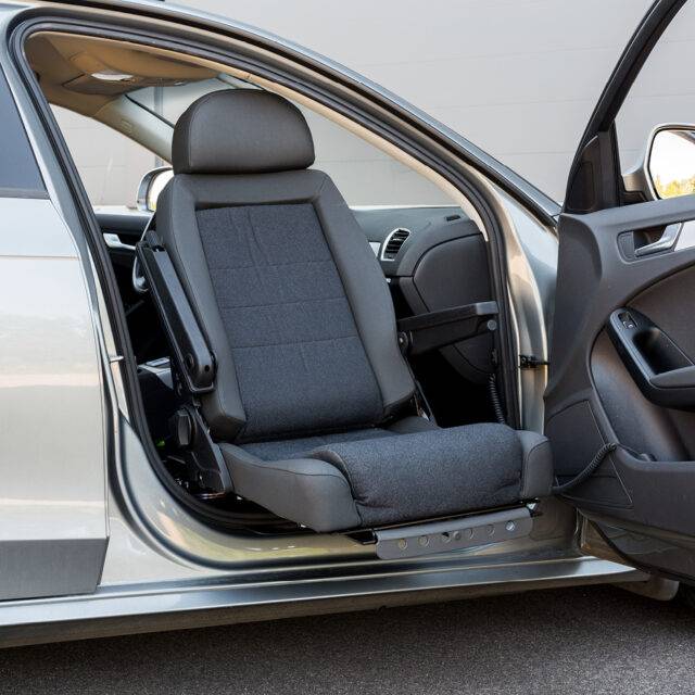 A swivel seat that has turned out of the driver's seat outside of the car to allow for easier access to the vehicle.