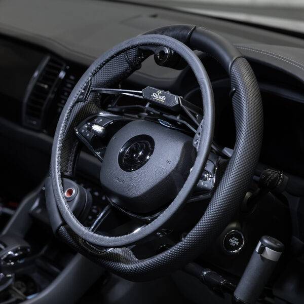 A car steering wheel with an over ring accelerator fitted above it