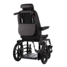 A Carony Wheelchair Swivel seat. The car seat has been transferred out of the car and is positioned on the wheelchair base. The back of the chair shows its handles for the carer to push and control the brakes for the seat