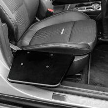 The BraunAbility Transfer Board. A small black folding platform positioned next to the driver's seat of the car.