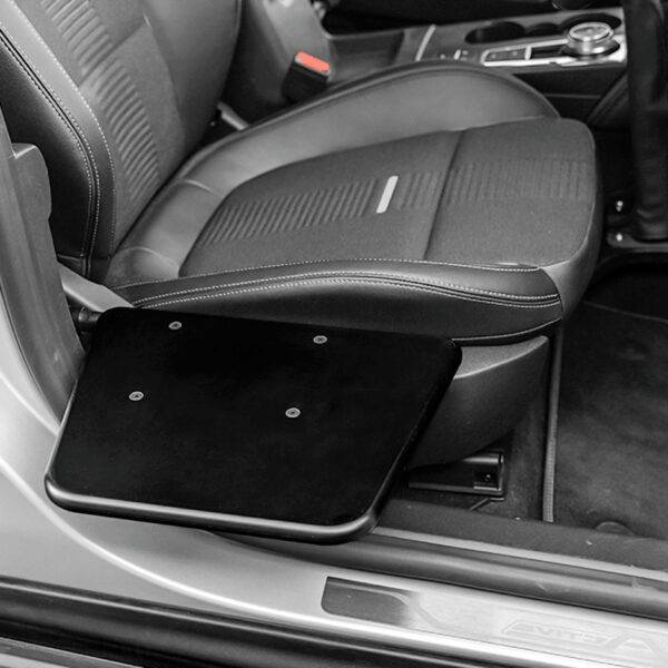 The BraunAbility Transfer Board. A small black folding platform positioned next to the driver's seat of the car.
