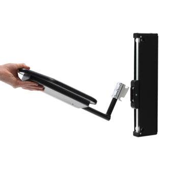 A hand holding the removable plate of the BAS Electric Transfer Plate. A small black platform with an electric mechanism to raise and lower its height for the car and seat.