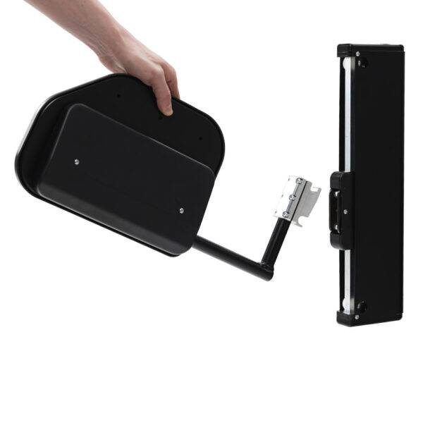 A hand holding the removable plate of the BAS Electric Transfer Plate. A small black platform with an electric mechanism to raise and lower its height for the car and seat.
