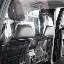 The rear seats of a car separated from the front passenger and driver by a robust transparent polycarbonate Driver shield for safely. The screen has additional padded panels to reduce the risk of injury.