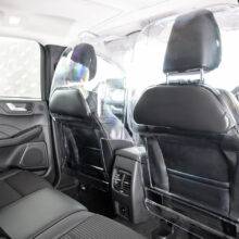 The rear seats of a car separated from the front passenger and driver by a robust transparent polycarbonate Driver shield for safely. The screen has additional padded panels to reduce the risk of injury.