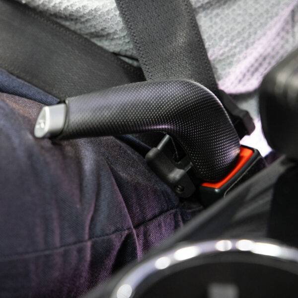 A car seatbelt with an additional handle to aid in connecting and unbuckling the belt