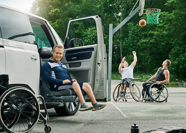 A young man sat on the Turny Evo swivel seat has turned the driver's seat out of the car and lowered it down to bring him to an ideal height for getting in and out of the vehicle and transferring to his wheelchair.