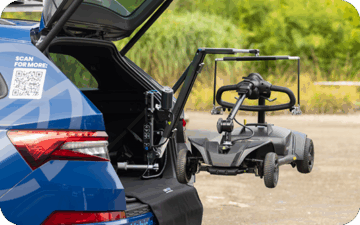 A car with a boot hoist lifting a scooter up to the boot