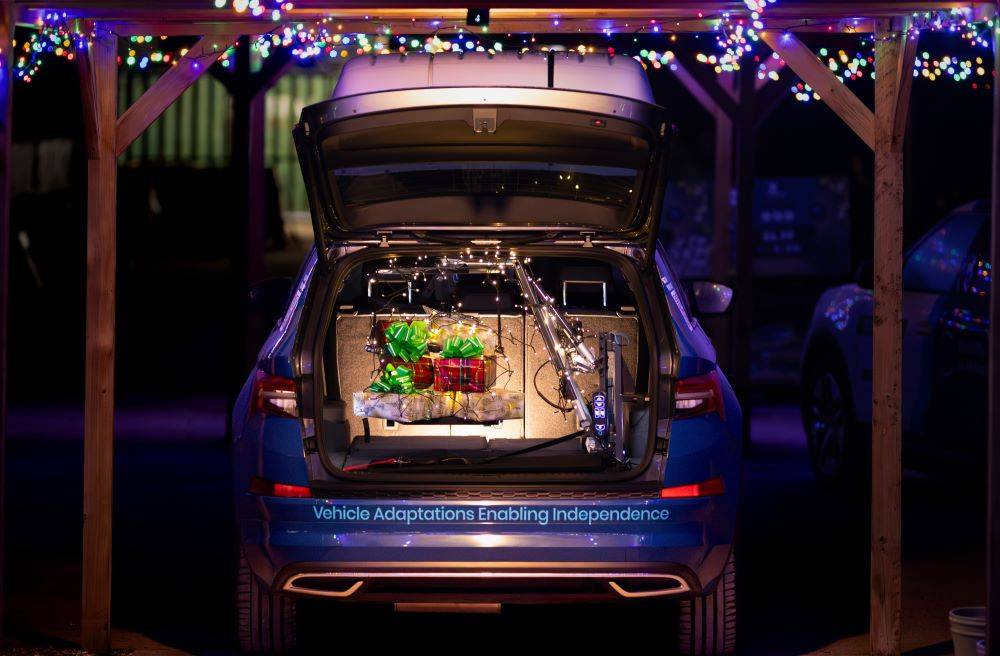 Mobility in Motion demo vehicle with boot hoist lifting Christmas presents