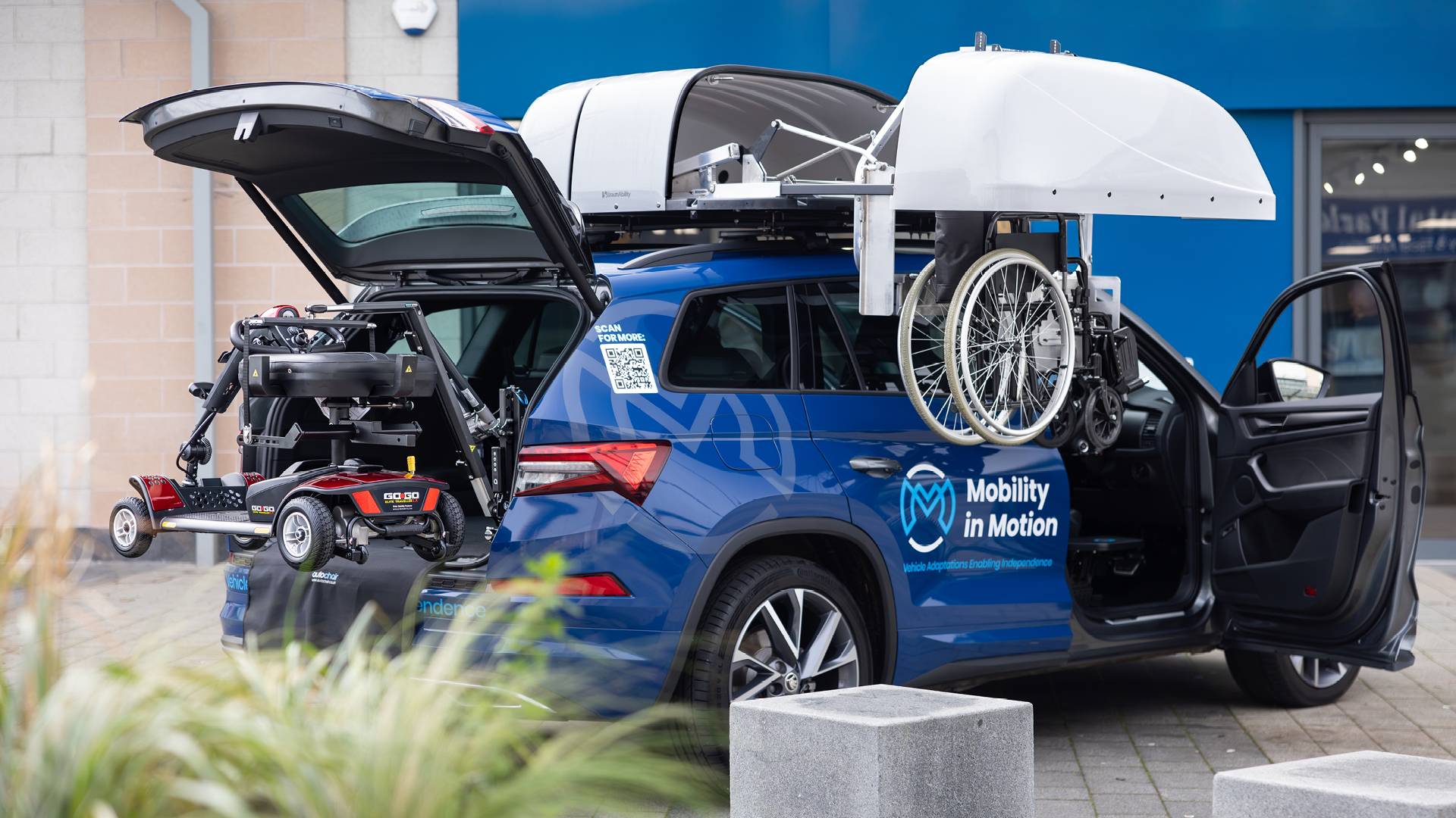 Mobility in Motion demo car with Wheelchair Rooftop Box and boot hoist lifting a mobility scooter.