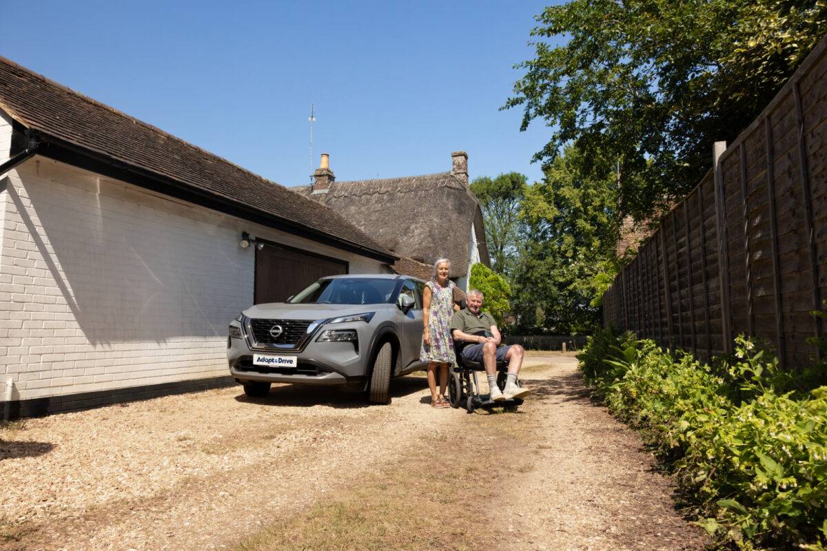 Elizabeth and Ian posing with the wheelchair carony swivel seat fitted in their Nissan X Trail Adapt & Drive car