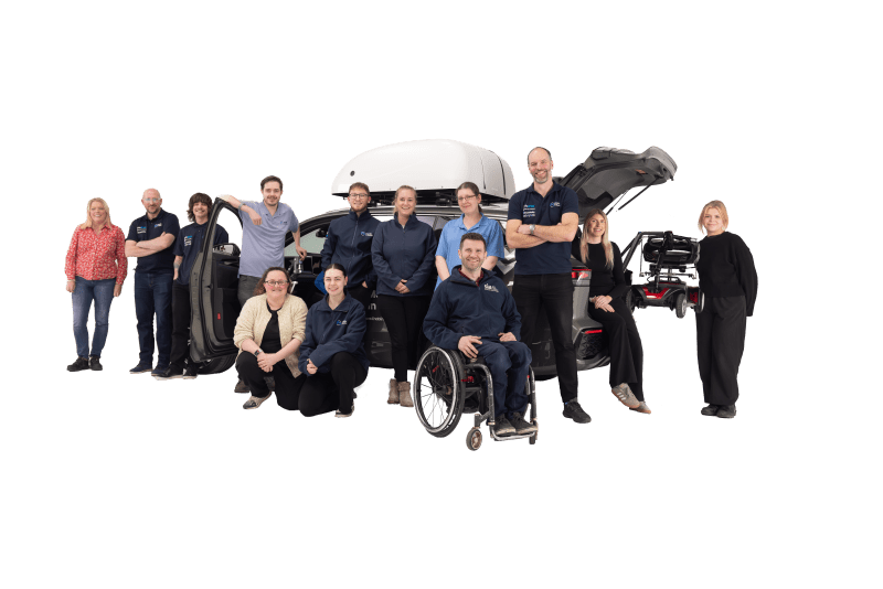 Mobility in Motion team members around an adapted car.