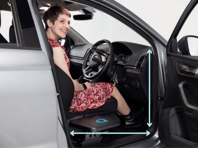 Young woman sat in drivers seat smiling with a transfer plate fitted. Arrows highlight the door width and door height.