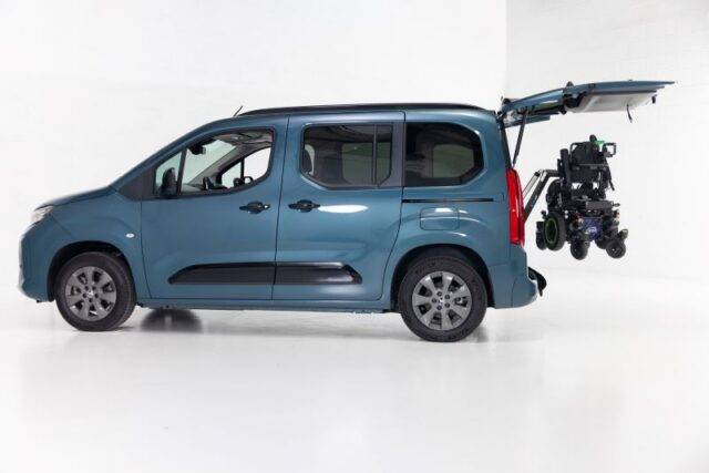 Adapt & Drive blue Vauxhall Combo Life fitted with a boot hoist lifting a powerchair
