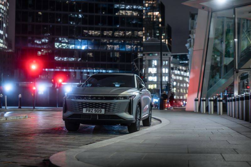 grey OMODA 9 parked in the city at night