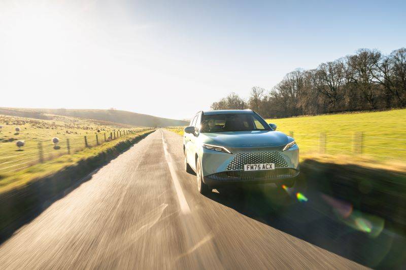 OMODA 7 driving down a country road with blue skies