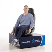 Robyn Love in a studio demonstrating a BraunAbility manual swivel seat.