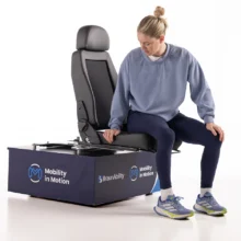 Robyn Love in a studio demonstrating a BraunAbility manual swivel seat.